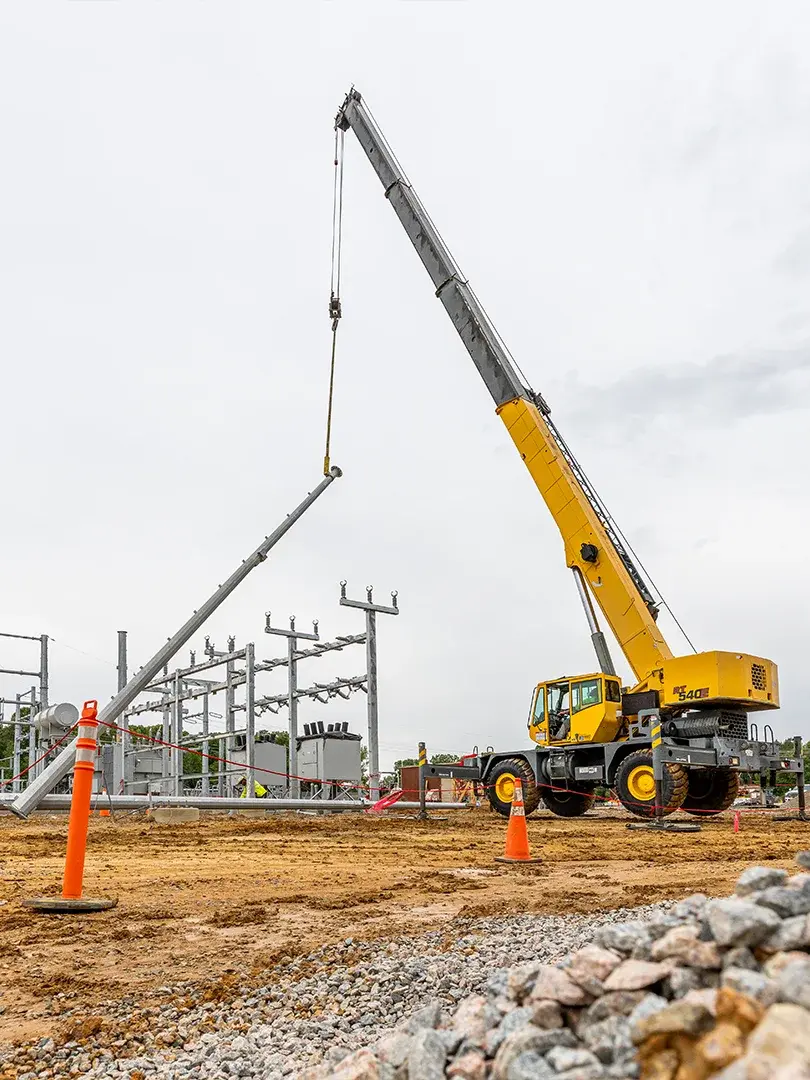 crane placing pole to vertical position